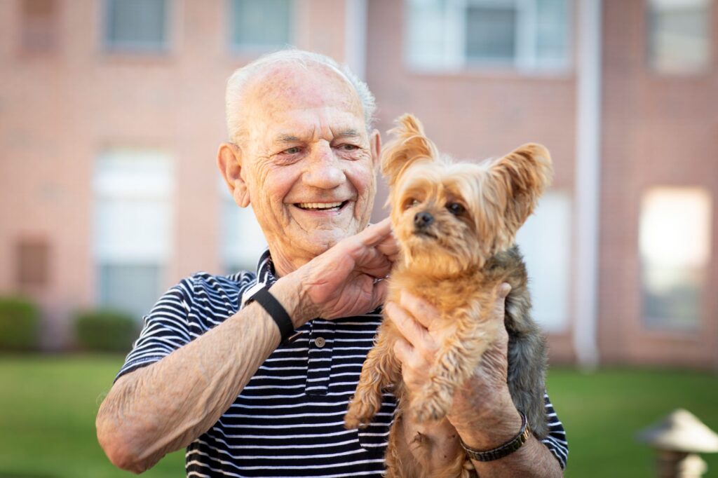 Man holding pet yorkie dog